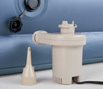 Electric pump and adapter sitting on floor next to Beautyrest Posture Lux air mattress